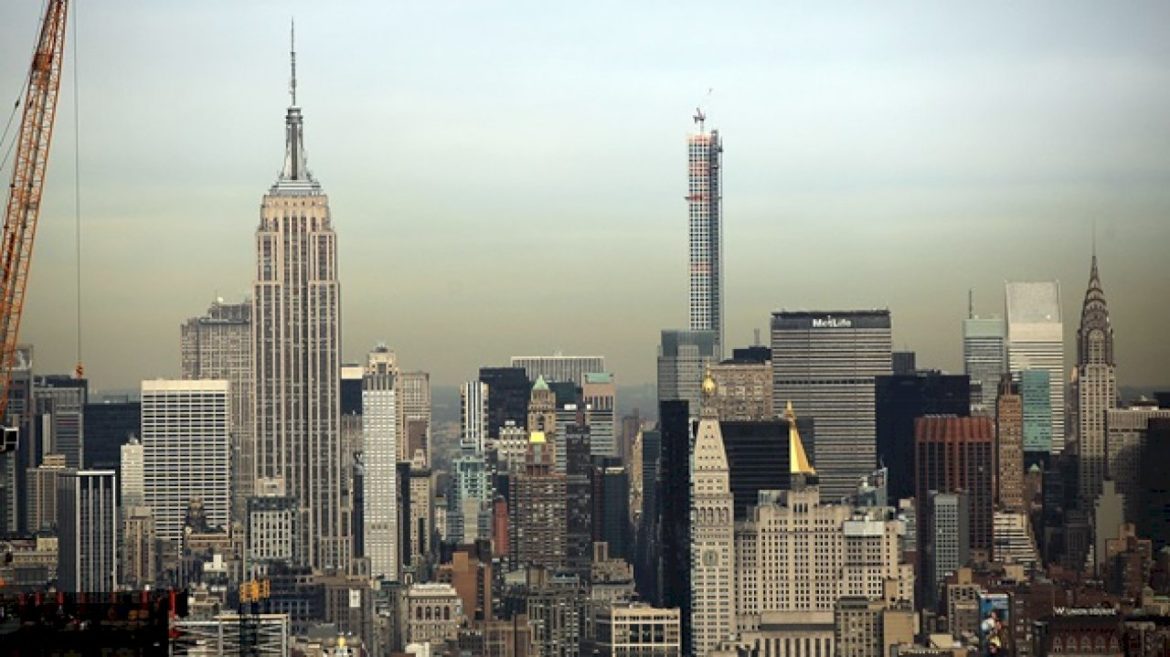 2-people-climb-to-the-top-of-empire-state-building-spire,-unfurl-banner